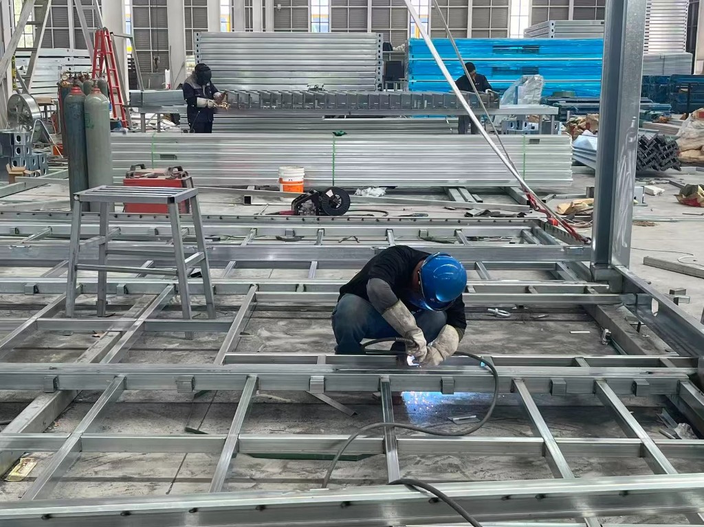 Workers welding steel frames