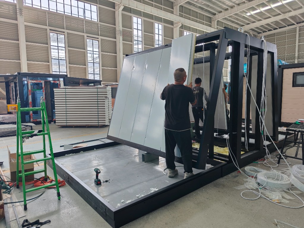 Workers assembling modular wall panels