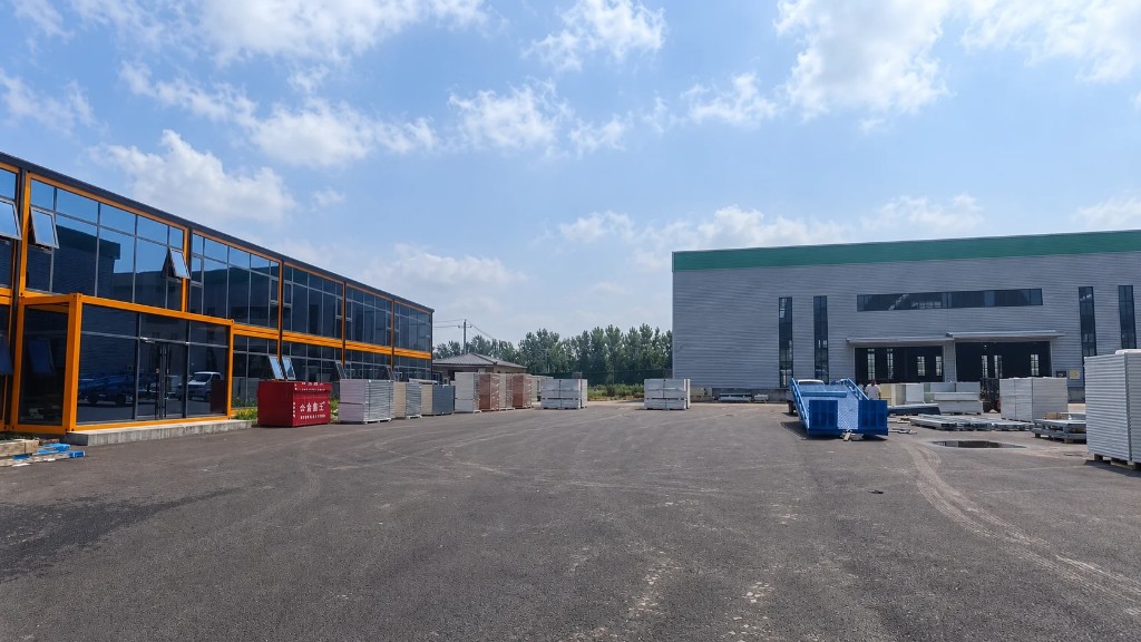 Factory yard with modular glass building and warehouse