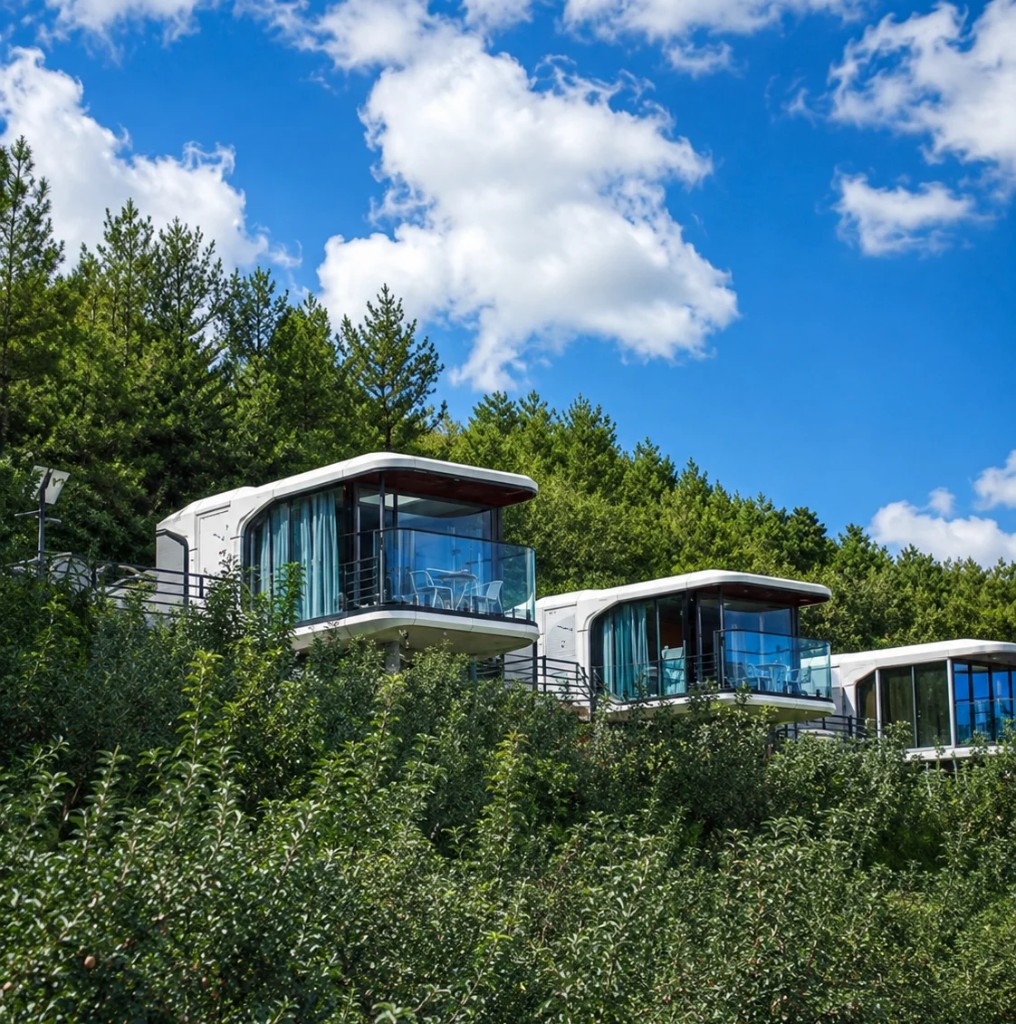 Capsule pods overlooking forest hillside